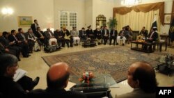 Pakistani Prime Minister Raja Pervez Ashraf (top right) talks with Afghan parliament members during a meeting in Islamabad on December 11.