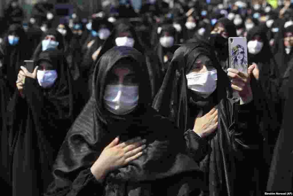 Mourning women wear protective face masks to help prevent the spread of the coronavirus during the annual ceremony commemorating Ashura at the Saleh shrine in northern Tehran on August 30.