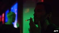 A man smokes in a bar in central Moscow. Some bar managers are saying the smoking ban actually helps business.
