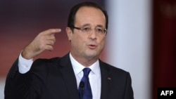 French President Francois Hollande announces French backing of the new Syrian opposition coalition at a major press conference at the Elysee Place in Paris on November 13.