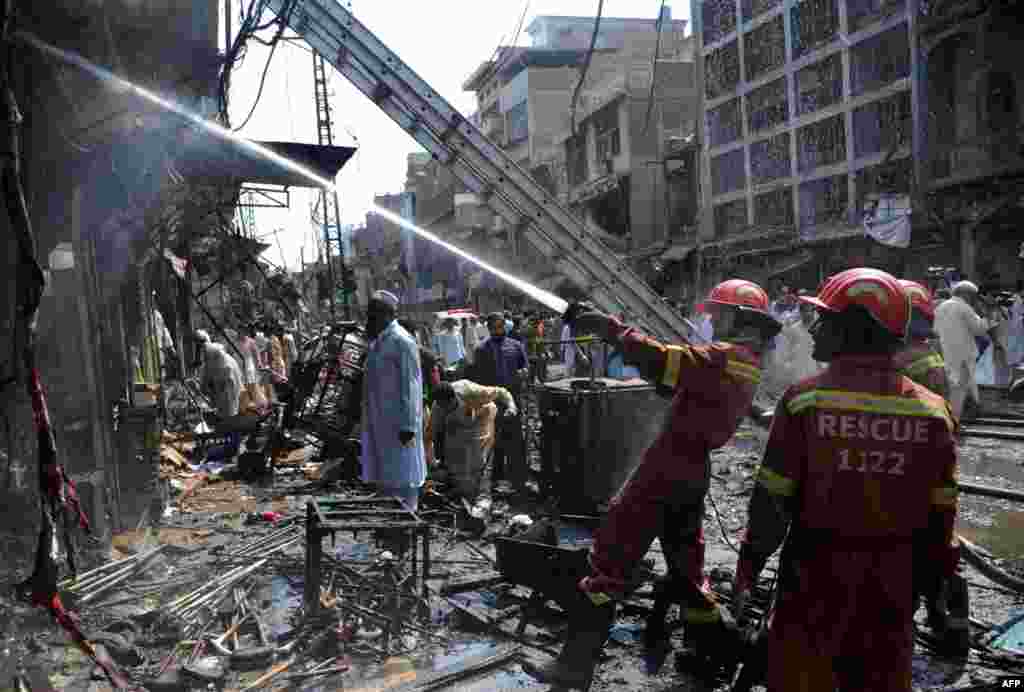 Firefighters extinguish a blaze started by the twin explosions. 