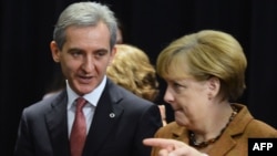 Moldovan Prime MInister Iurie Leanca (left) talks with German Chancellor Angela Merkel during the European Union's Third Eastern Partnership Summit in Vilnius on November 29.