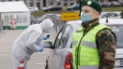 Lithuania - Vilnius, Lithuania, march 19, 2020. Medical staff in protective gear collects samples for COVID-19 coronavirus at the drive-in mobile testing center organized in Vilnius city, Lithuania