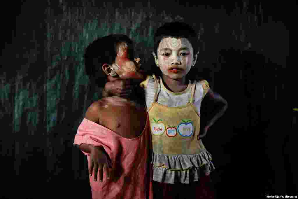 Rohingya refugee sisters Nur Kaida (right) and Ruhana hug each other at their shelter at the Palongkhali refugee camp near Cox's Bazar, Bangladesh. (Reuters/Marko Djurica)