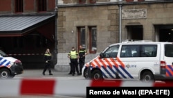 Dutch police officers stand attend the scene of a stabbing attack near Amsterdam's Central Station on August 31.