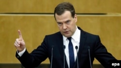 Russian Prime Minister Dmitry Medvedev delivers a speech during a session of the State Duma in Moscow on April 21.