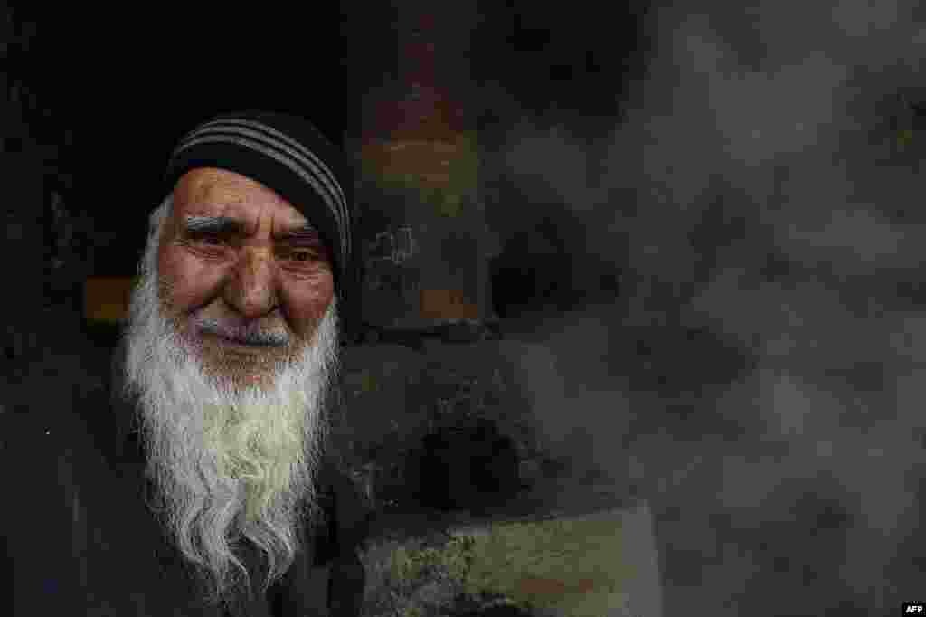 An Afghan blacksmith looks on as he works at his shop in the capital, Kabul. (AFP/Shah Marai)