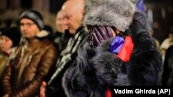 A woman cries during an antigovernment protest in Bucharest on December 22 to demand greater democracy, during a march to commemorate the victims of the 1989 anticommunist revolt.