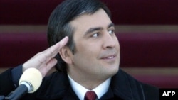 A young Saakashvili salutes during his inauguration ceremony in 2004. Many held high hopes for his leadership. 