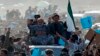 Abdullah Abdullah (in gray) sits atop a vehicle at an election rally in the Panjshir Province on March 31, 2014.