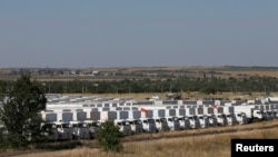 A Russian convoy of trucks carrying humanitarian aid for Ukraine waits at a camp near Kamensk-Shakhtinsky, in Russia's Rostov region.