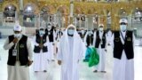 Saudi Arabia, Men wearing protective face masks stand as they work on raising the Kiswa, a silk cloth covering the Holy Kaaba, before the annual pilgrimage season, at the Grand Mosque in Mecca, Saudi Arabia July 22, 2020. 