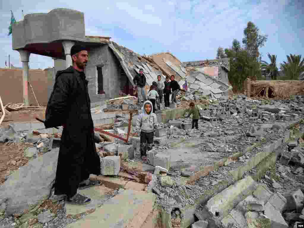 An Iraqi Turkoman stands among the rubble of his home destroyed in fighting between Iraqi security forces and Islamic State militants east of Tikrit on December 3. (epa/Ali Mohammed)