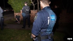 A man is arrested following the execution of search warrants in the northwest suburbs of Sydney on September 18.