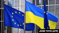 پرچم‌های اوکراین و اتحادیه اروپا در نزدیکی ساختمان پارلمان اروپایی