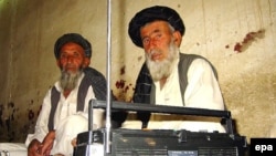 Afghan men listen to the radio at a tea shop in Spin Boldak.