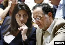 Greek Energy Minister and leader of the far-left wing of the ruling SYRIZA party Panagiotis Lafazanis (right) and Parliament Speaker Zoe Constantinopoulos before a meeting of the ruling SYRIZA parliamentary group in Athens on July 15, 2015