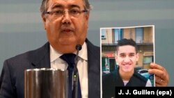 Spanish Interior Minister Juan Ignacio Zoido shows a picture of Younes Abouyaaqoub, identified as the driver of the van in the Barcelona massacre, during a press conference in Madrid on August 21.