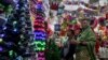 A Christian family browses Christmas ornaments to decorate their home for upcoming celebrations at a shop in Lahore, Pakistan. (AP/K.M. Chaudhry)