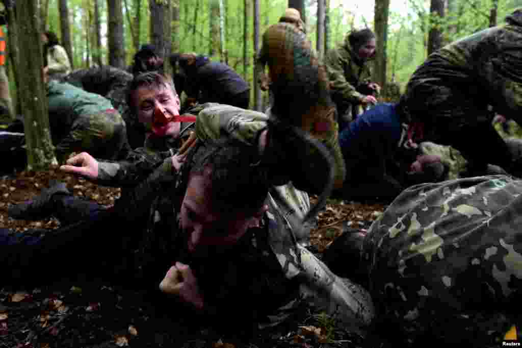 Young people take part in hand-to-hand combat practice during a military survival game in the Ternopil region of Ukraine. (Reuters/Maksim Levin)