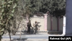 Afghan soldiers take a position near the Shamshad Television after an attack in Kabul on November 7.