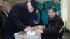 Armenia - A voter in Yerevan casts a ballot in a presidential election, 18Feb2013.