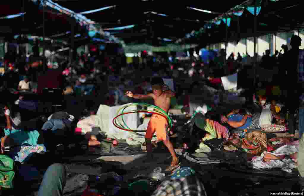 Osman Joel Hernandez, a 6-year-old migrant boy, part of a caravan of thousands traveling from Central America en route to the United States, plays with a hula hoop as he rests in a makeshift camp in Juchitan, Mexico, on October 31. (Reuters/Hannah McKay)