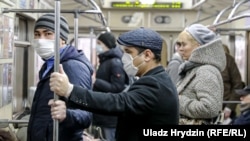 People wear face masks as they ride the subway in Minsk on April 20.