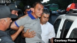 Rovshan Nasirli being detained by police at a pro-democracy rally in Baku on June 19.