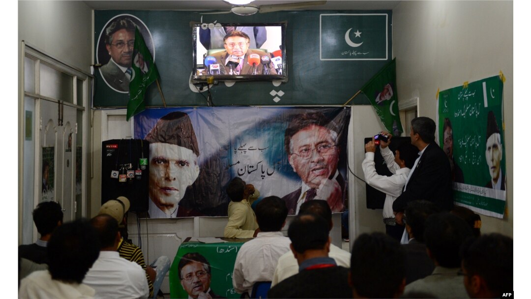 Activists of the All Pakistan Muslim League watch in Karachi as Musharraf speaks to reporters about his return from self-imposed exile on March 1.