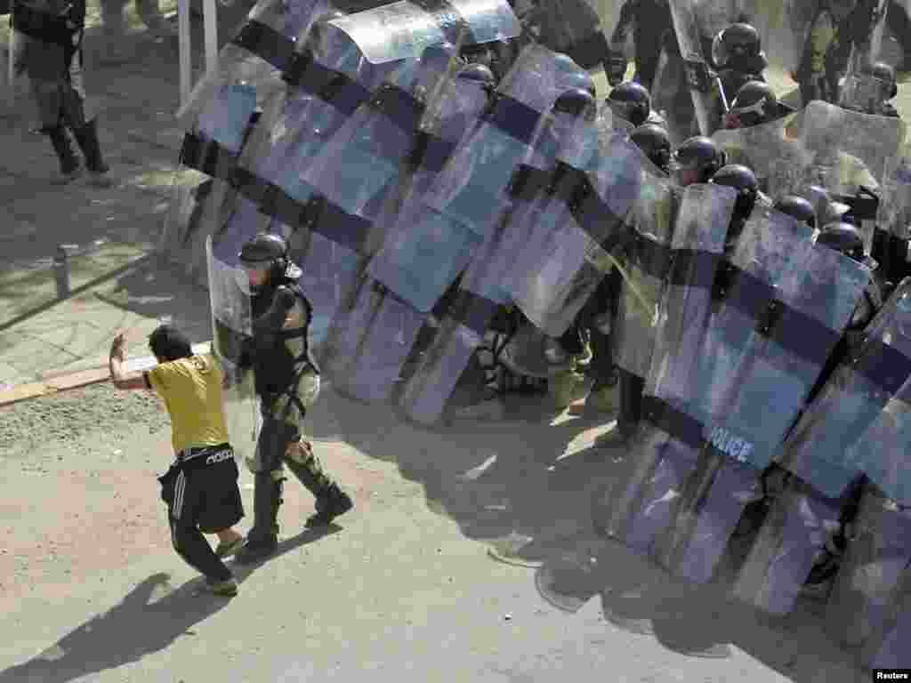 Riot policemen in position during a demonstration in central Baghdad.