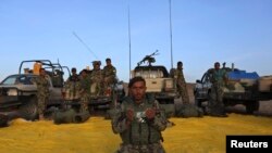 File photo of an Afghan National Army soldier prays outside a military base in a remote region of Herat province.