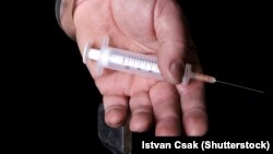Generic - Drug addict man hold an injection and wearing handcuffs, drugs, heroin, ©Shutterstock, undated