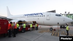 Armenia -- Workers at Zvartnots airport in Yerevan load relief supplies onto a plane bound for Lebanon, August 8, 2020.