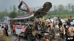 Pakistani volunteers search a bus after it was ripped apart in an explosion in Peshawar on September 27. Schoolteacher Haroon-ur-Rashid was one of the 19 who died on the bus.