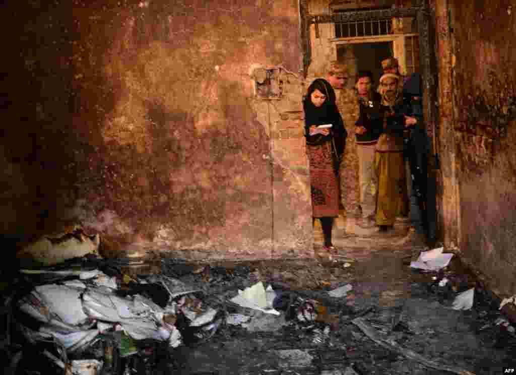 A Pakistani soldier shows the media a burned classroom at an army-run school, one day after an attack by Taliban militants in Peshawar killed 141 people, including 132 children, on December 16. (AFP/A Majeed)