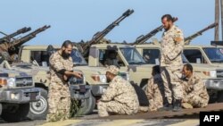 Forces loyal to Libya's UN-backed unity government take up positions in a suburb of Tripoli on April 6.