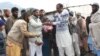 Members of Jamaat-ud-Dawa distributing food at a relief camp in Muzaffarabad