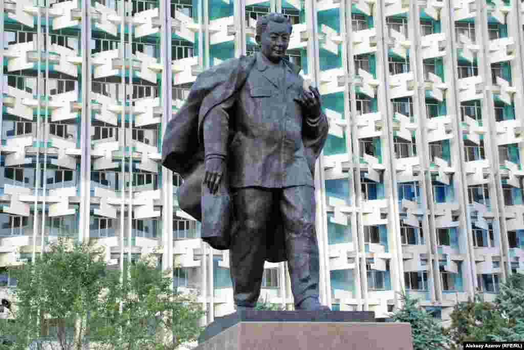 В 1999 году, когда отмечали 100-летие со дня рождения Каныша Сатпаева, его имя было присвоено Казахскому национальному техническому университету (в советское время это был Политехнический институт имени В. И. Ленина) в Алматы. В том же году перед зданием КазНТУ был открыт бронзовый памятник Сатпаеву. Его авторы – скульптор Толеген Досмагамбетов и архитектор Арыстан Кайнарбаев. На фото – памятник Сатпаеву на фоне самого позднего по времени постройки корпуса университета, выходящего на перекресток улиц Байтурсынова и Сатпаева. 