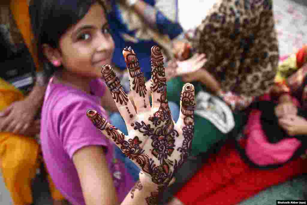 A Pakistani girl shows henna tattoos on her hand in Karachi.