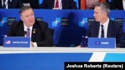 U.S. Secretary of State Mike Pompeo (left) speaks as NATO Secretary-General Jens Stoltenberg listens during a NATO meeting in Washington on April 4. 