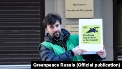 A Russian Greenpeace activist protests the plight of the whales near the presidential administration.