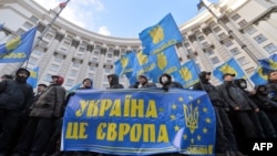 Protesters hold a sign saying "Ukraine is Europe" as they block the Cabinet of the Ministers building in Kyiv on December 2.