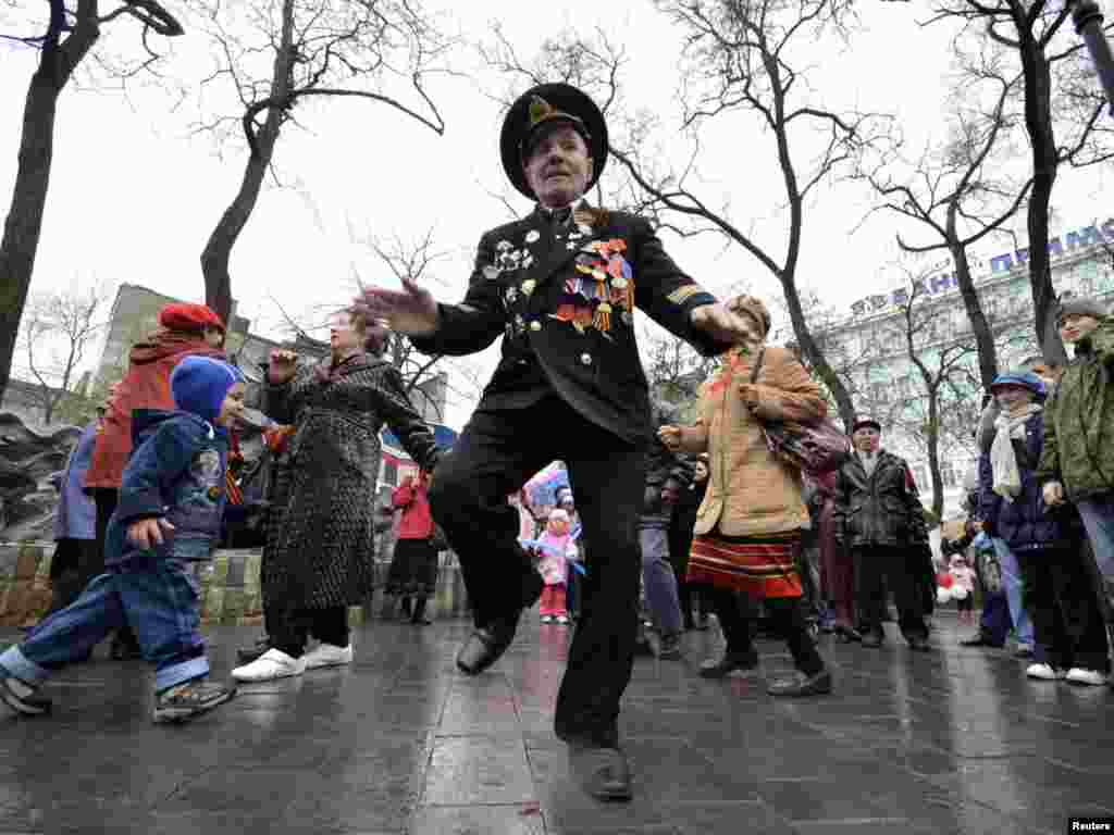 A Russian war veteran dances during Victory Day celebrations in the far eastern city of Vladivostok on May 9. Photo by Yury Maltsev for Reuters