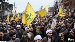 Members of Iran's Fatemiyoun Division, mostly Afghans, attend Soleimani's funeral in Tehran on December 6, 2020.