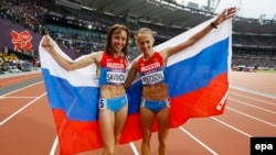 Russia's Mariya Savinova (keft) and Ekaterina Poistogova celebrate after placing first and third, respectively, in the women's 800-meters final at the 2012 Summer Olympics in London. The two athletes are being targeted for lifetime competition bans.