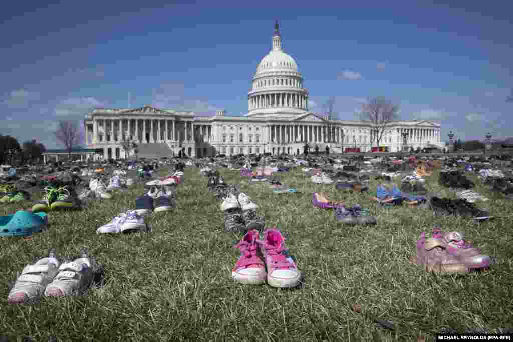 Approximately 7,000 pairs of shoes representing children killed in the U.S. by guns since the December 14, 2012, shooting at Sandy Hook Elementary School in Newtown, Connecticut, are seen in front of the U.S. Capitol in Washington, D.C., in a protest organized by a global advocacy group. (epa-EFE/Michael Reynolds)