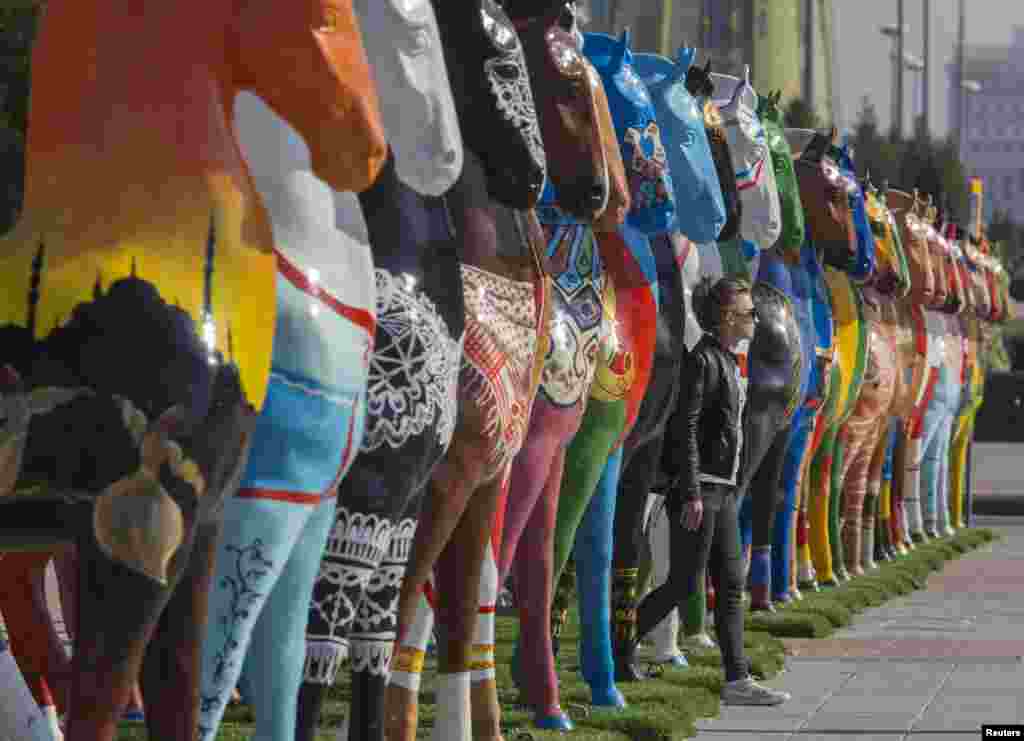 A woman walks past a street-art installation in Astana, Kazakhstan. (Reuters/Shamil Zhumatov)