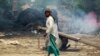 An Indian man walks near a residential area that was gutted from firing allegedly from the Pakistan side of the border in Jora farm village, in Ranbir Singh Pura district of Jammu and Kashmir in May.