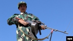 An Afghan National Army soldier stands guard at the Pakistan-Afghanistan border